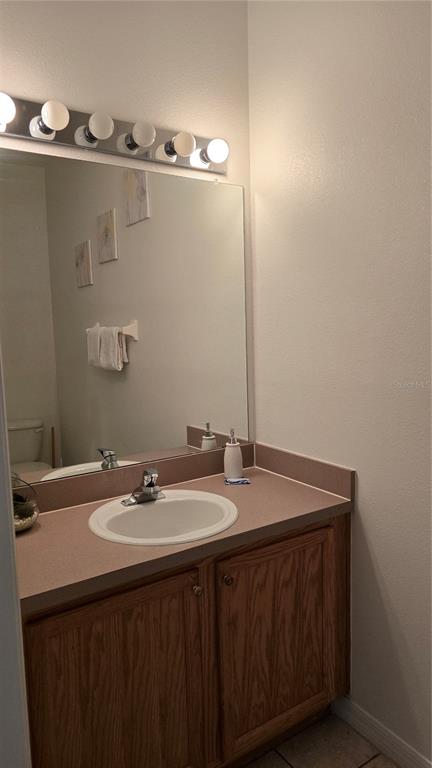 1013 Park Ridge Circle Kissimmee, FL 34746 - Photo 35 of 74 a bathroom with a sink and a mirror