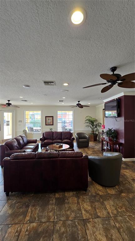 1013 Park Ridge Circle Kissimmee, FL 34746 - Photo 68 of 74 a living room with furniture a fireplace and a window