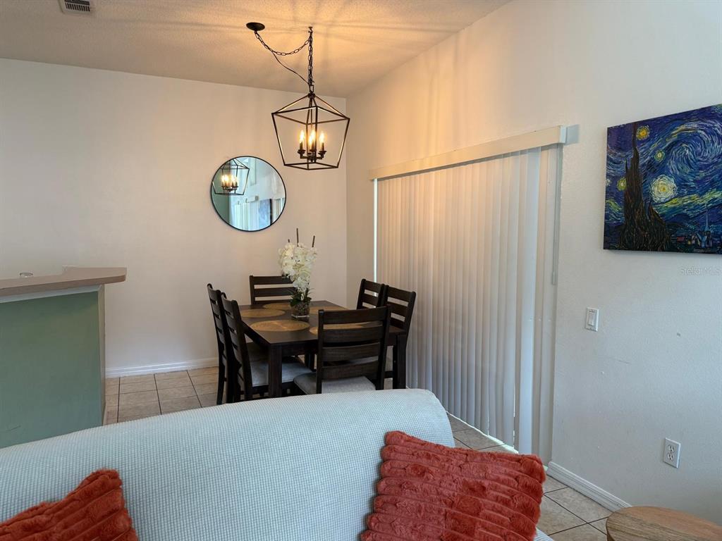 1013 Park Ridge Circle Kissimmee, FL 34746 - Photo 8 of 74 a view of a dining room with a table and chairs