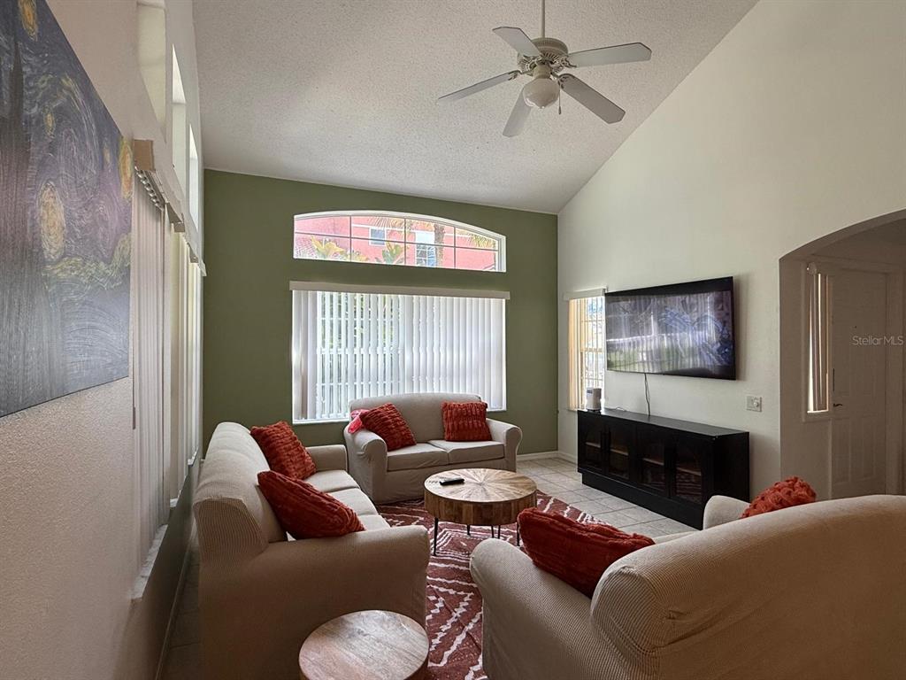 1013 Park Ridge Circle Kissimmee, FL 34746 - Photo 10 of 74 a living room with furniture and a flat screen tv
