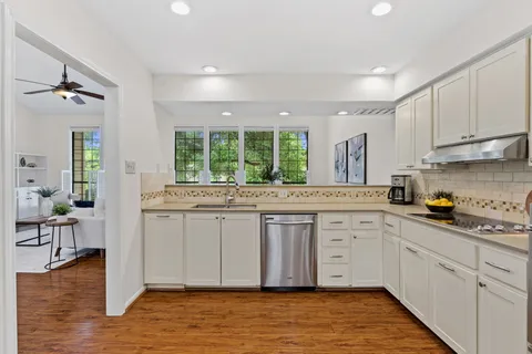 a kitchen with stainless steel appliances granite countertop a refrigerator and a stove top oven
