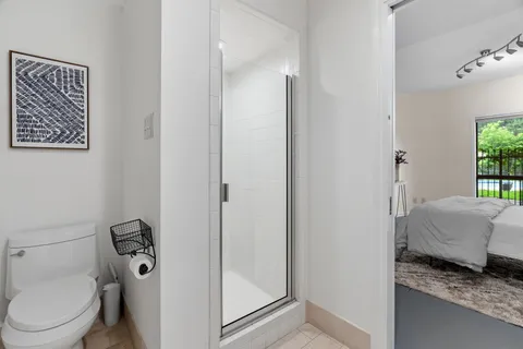a large bed sitting in a bedroom next to a window