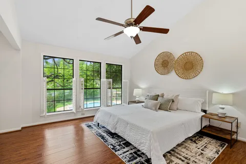 a bedroom with a large bed and a large window