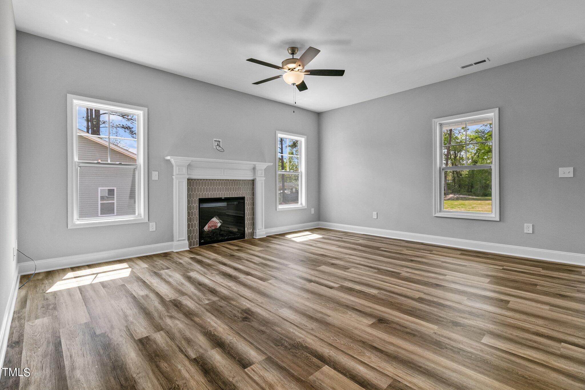 75 Regis Lane Coats, NC 27521 - Photo 11 of 37 a view of an empty room with wooden floor fireplace and a window