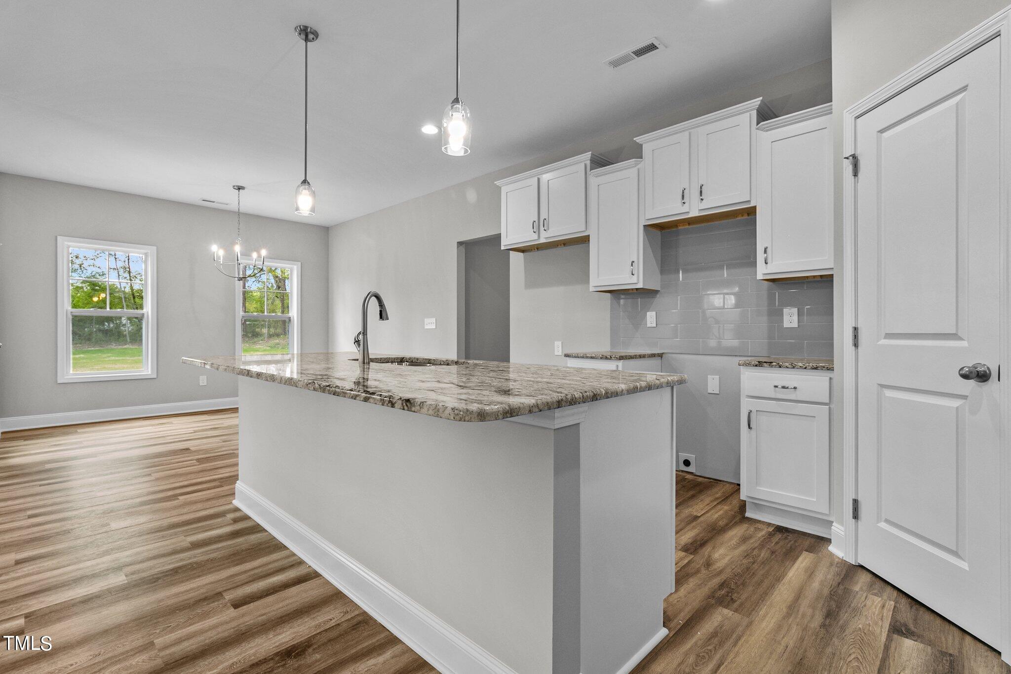75 Regis Lane Coats, NC 27521 - Photo 12 of 37 a kitchen with stainless steel appliances granite countertop a sink stove and refrigerator