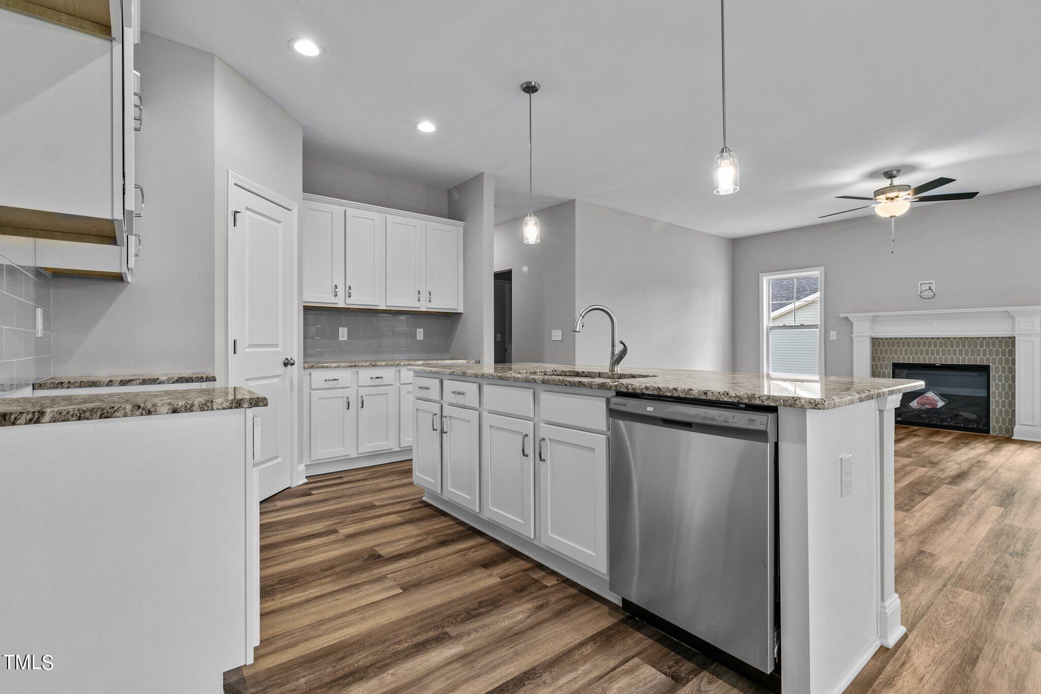 75 Regis Lane Coats, NC 27521 - Photo 13 of 37 a kitchen with granite countertop a sink cabinets stainless steel appliances and a counter top space