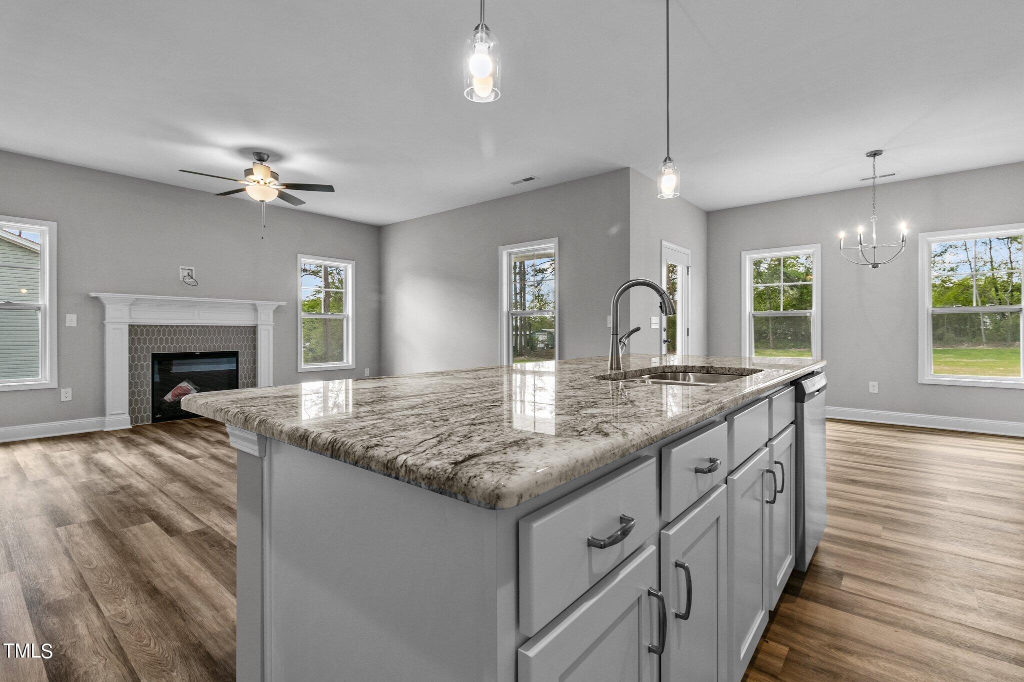 75 Regis Lane Coats, NC 27521 - Photo 14 of 37 a kitchen with granite countertop a sink center island with wooden floor