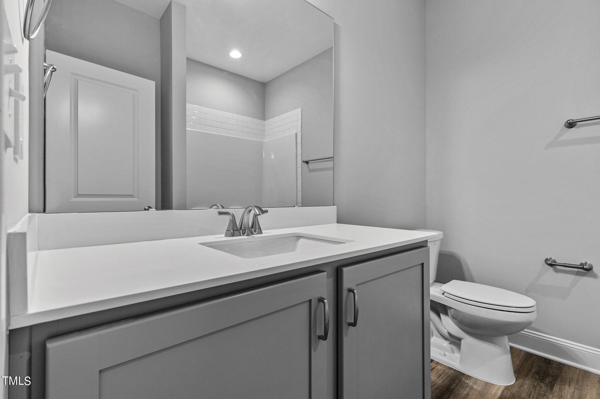 75 Regis Lane Coats, NC 27521 - Photo 21 of 37 a bathroom with a sink toilet and mirror