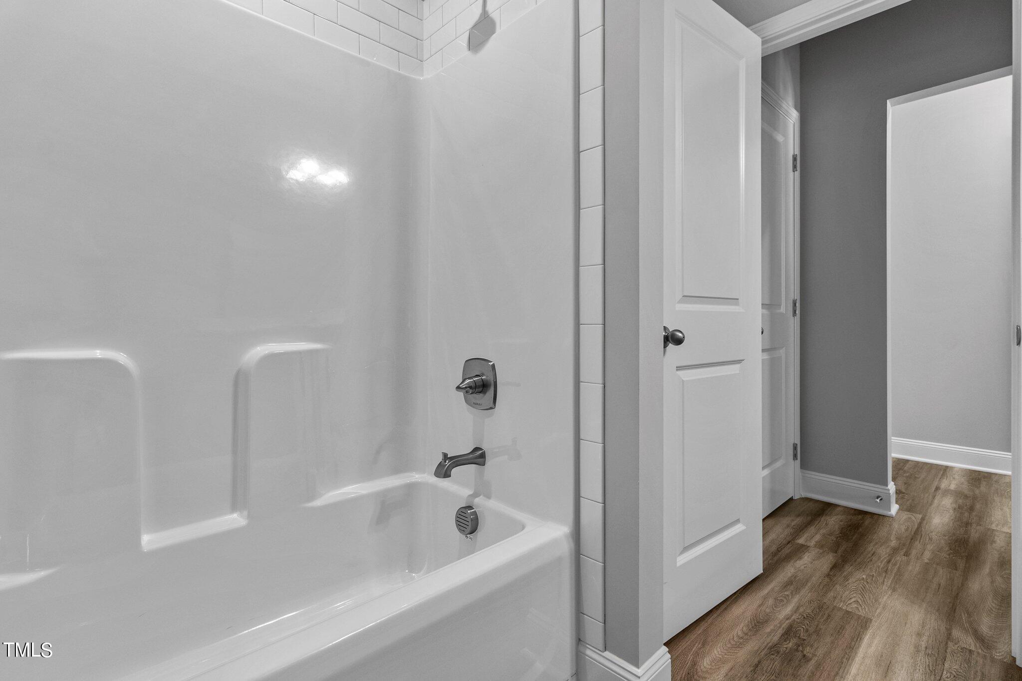 75 Regis Lane Coats, NC 27521 - Photo 22 of 37 a bathroom with a bathtub and a shower