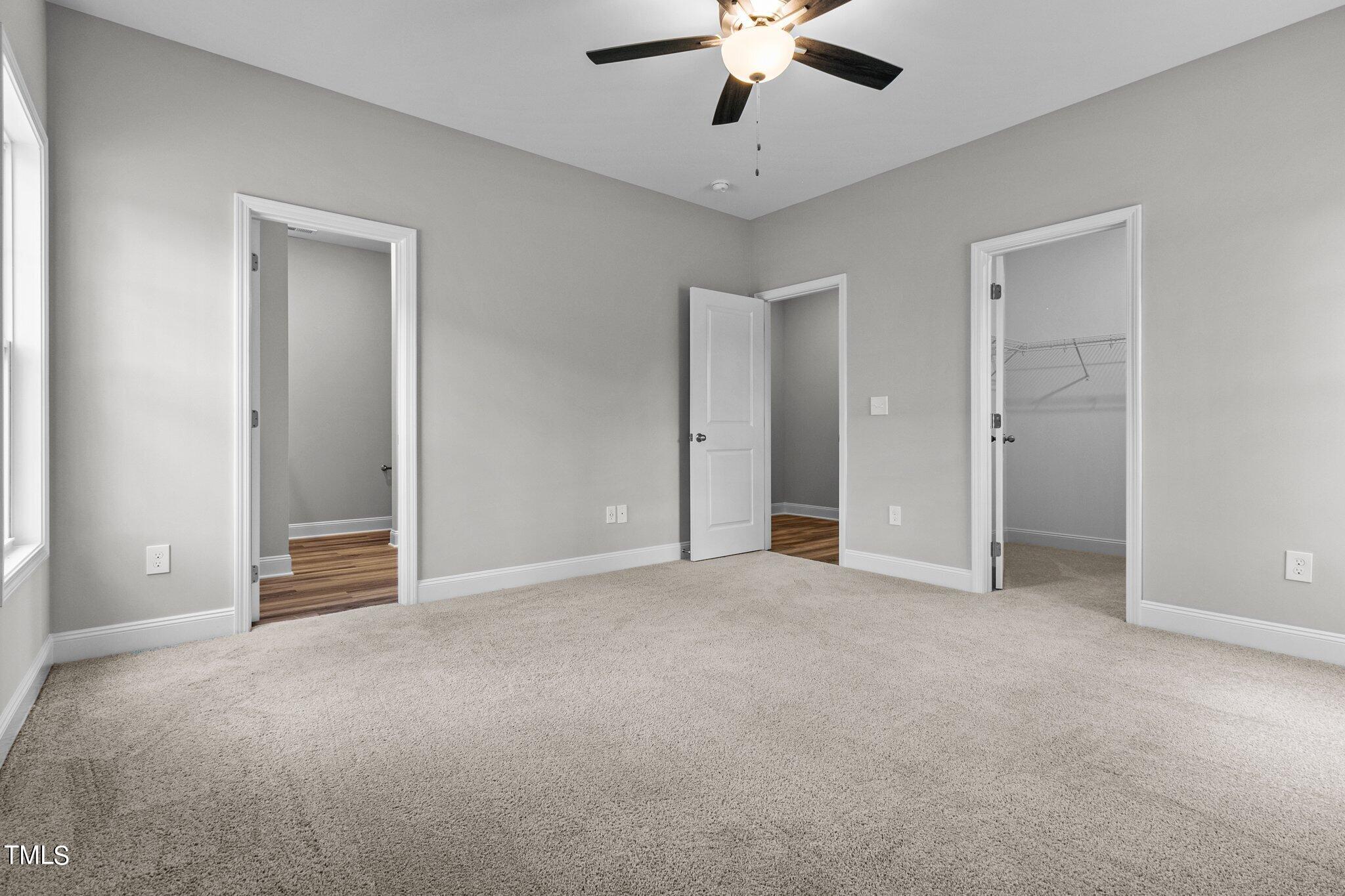 75 Regis Lane Coats, NC 27521 - Photo 26 of 37 an empty room with chandelier fan and windows