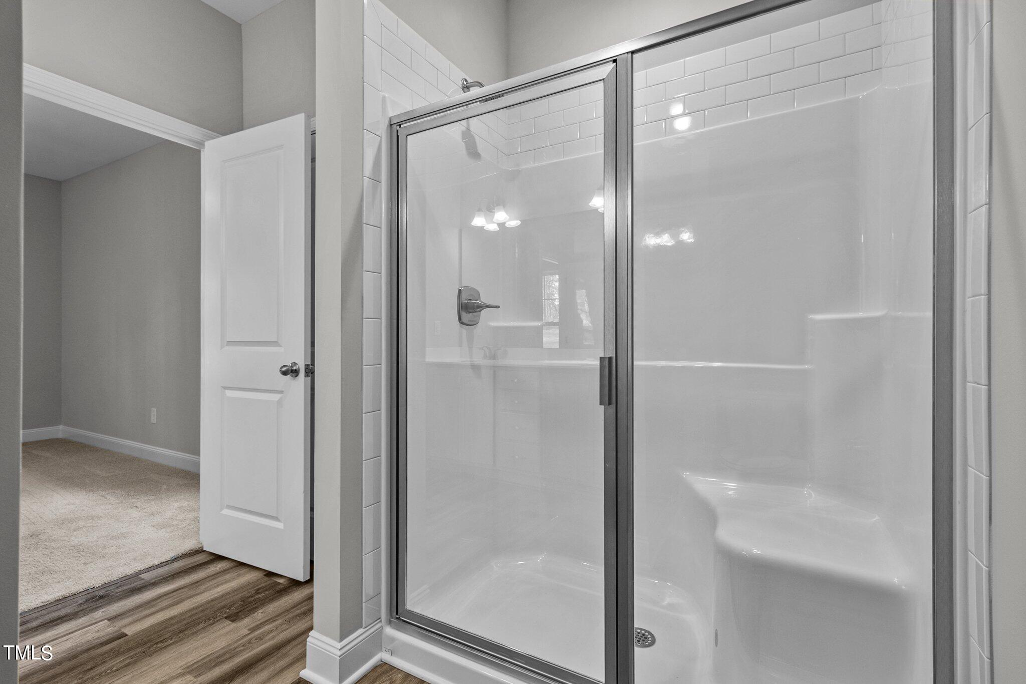 75 Regis Lane Coats, NC 27521 - Photo 28 of 37 a bathroom with a glass shower door