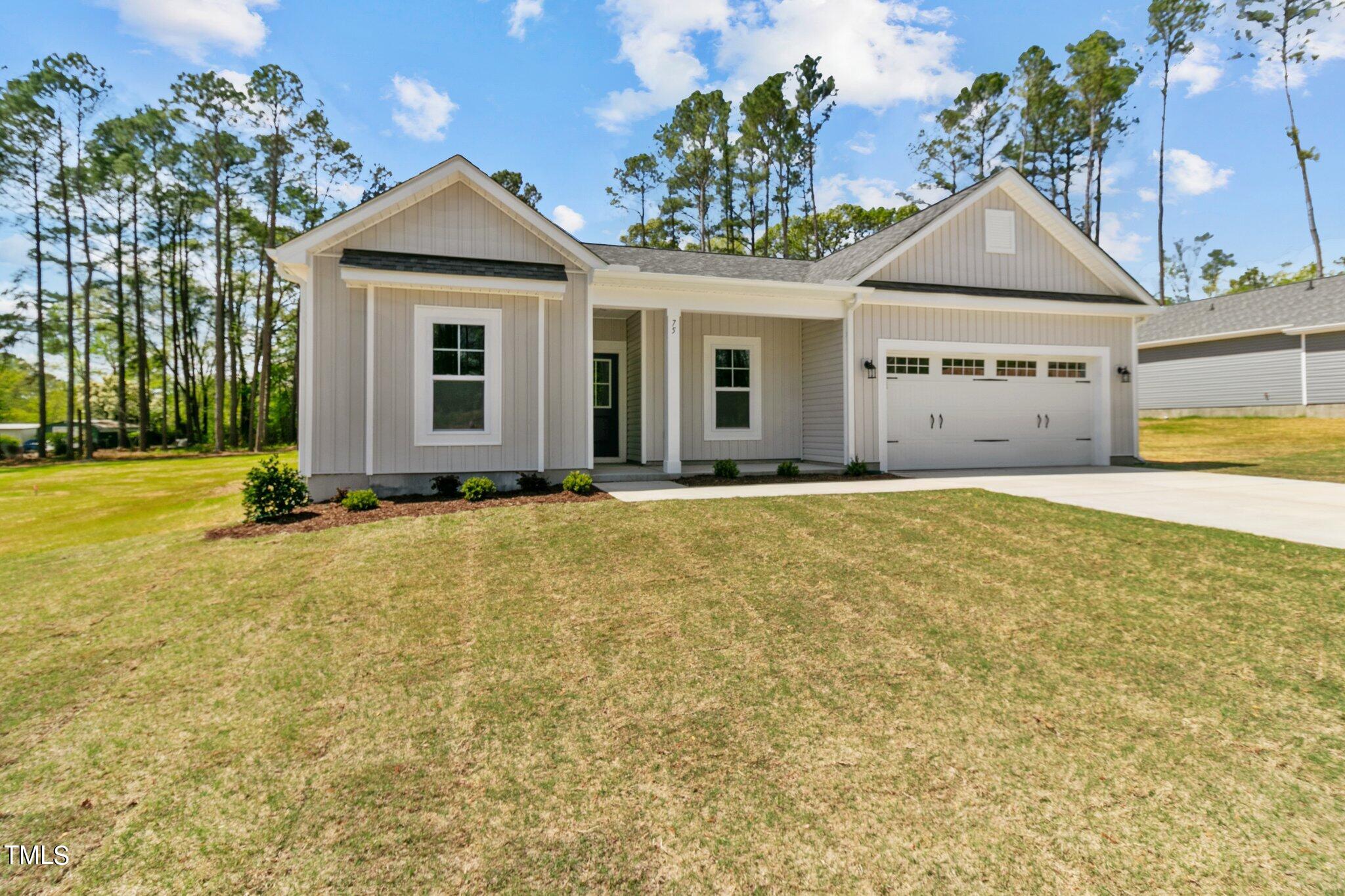 75 Regis Lane Coats, NC 27521 - Photo 3 of 37 a front view of a house with a yard