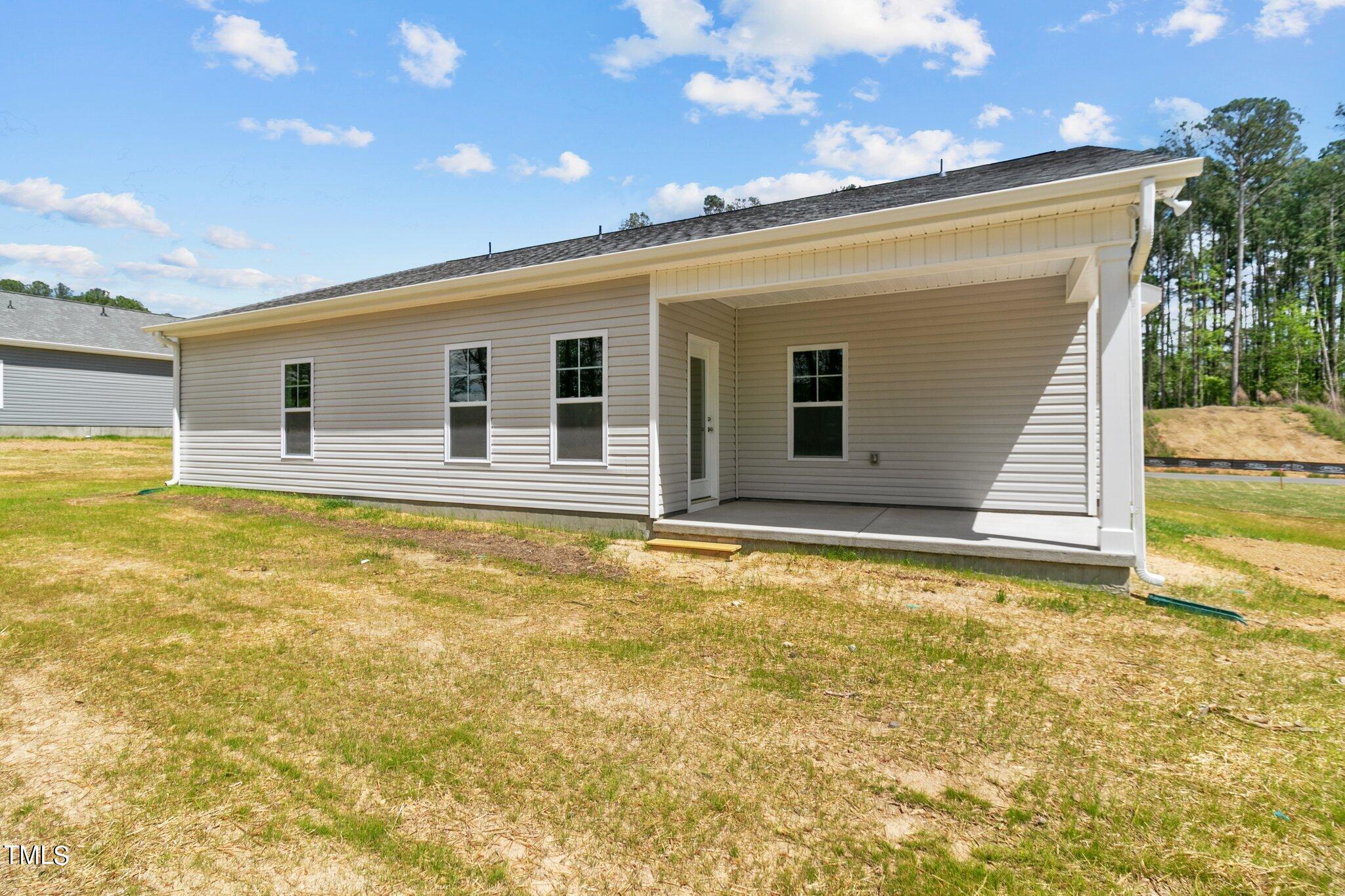 75 Regis Lane Coats, NC 27521 - Photo 31 of 37 a view of a house with a backyard