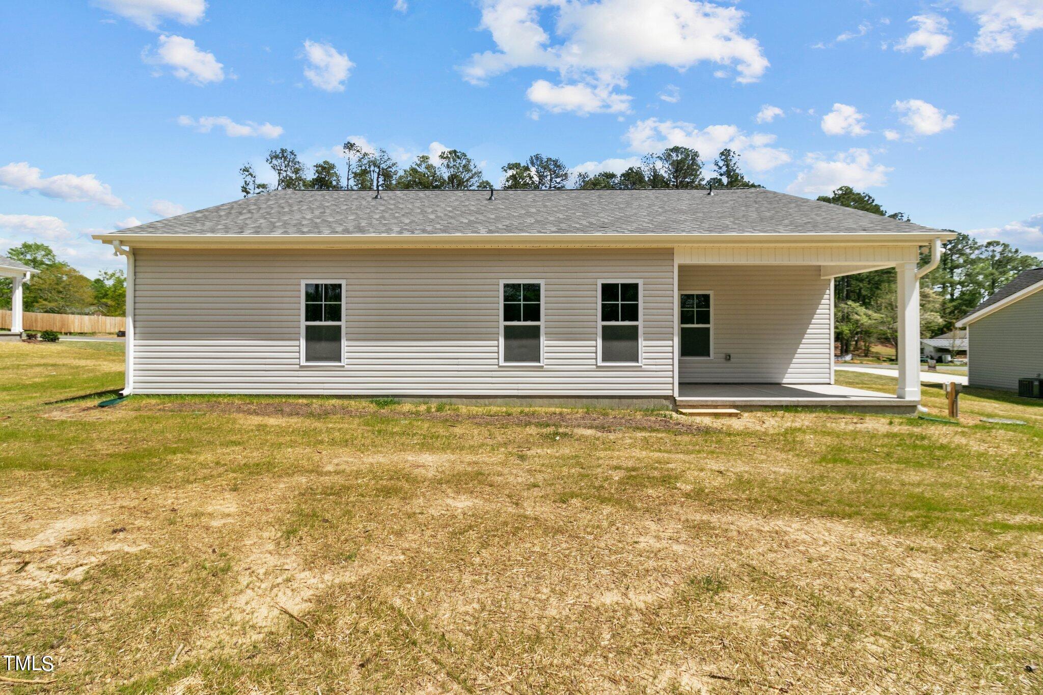 75 Regis Lane Coats, NC 27521 - Photo 32 of 37 a view of a house with a backyard