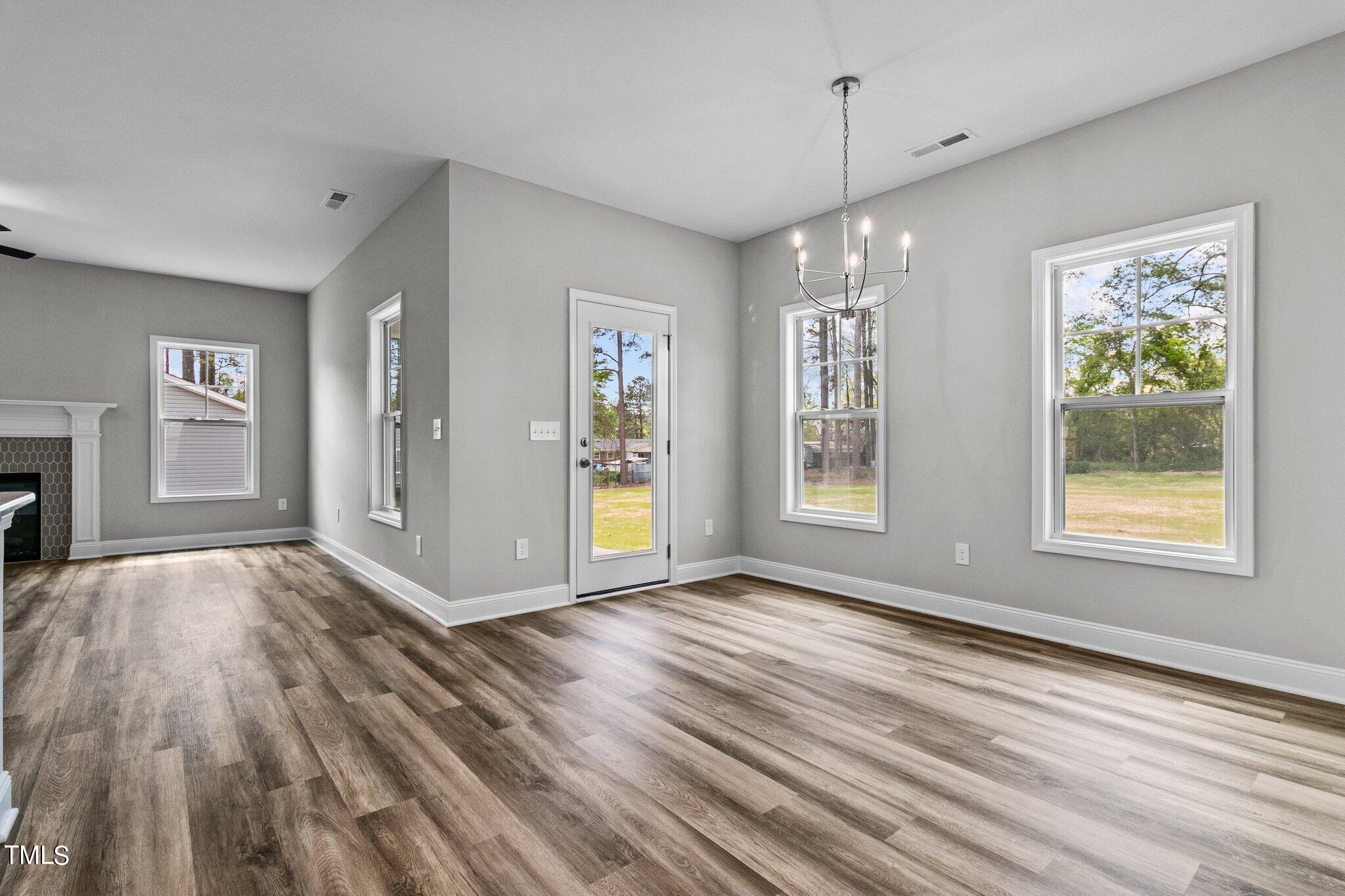 75 Regis Lane Coats, NC 27521 - Photo 5 of 37 a view of an empty room with window and wooden floor