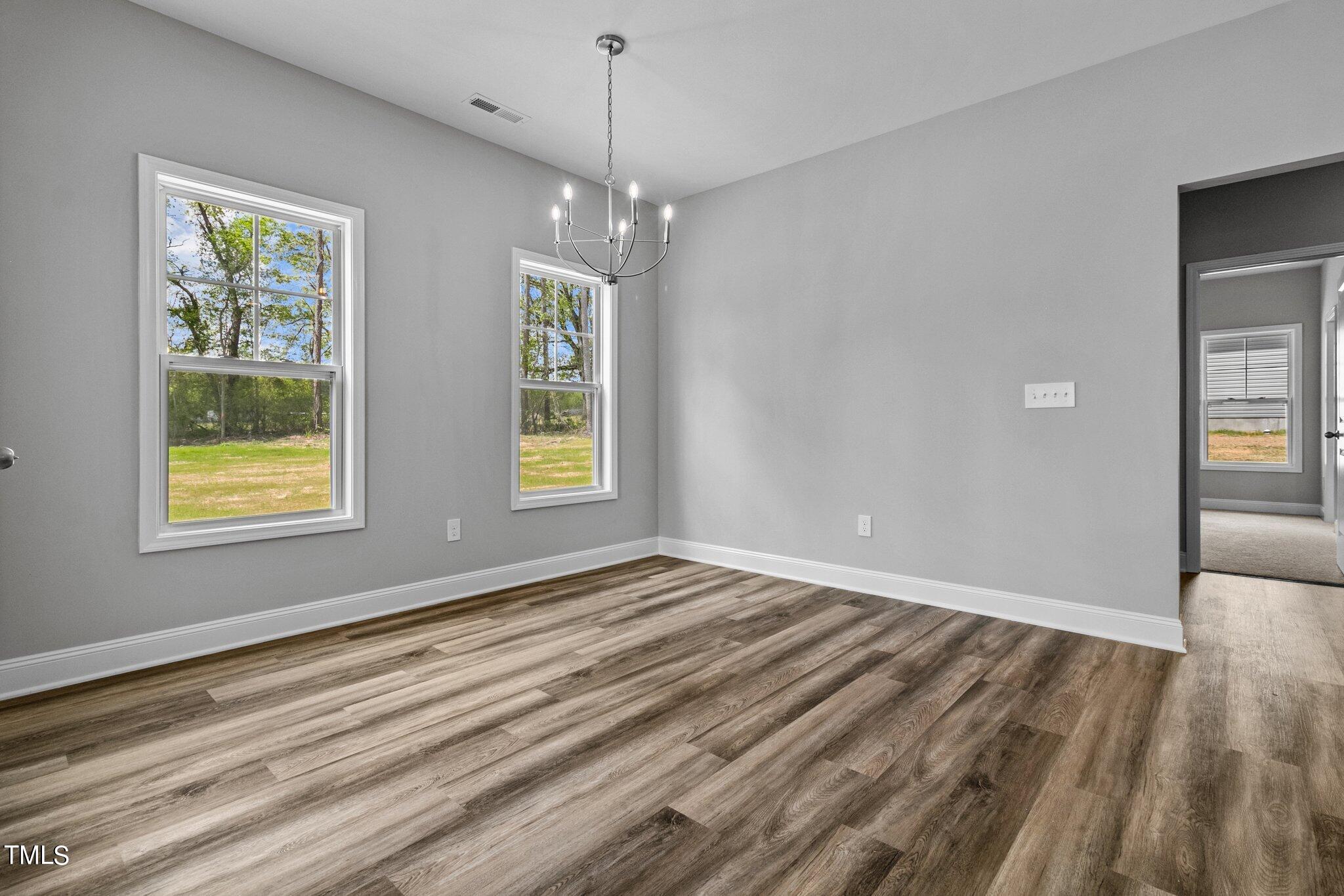 75 Regis Lane Coats, NC 27521 - Photo 8 of 37 a view of an empty room with window and wooden floor