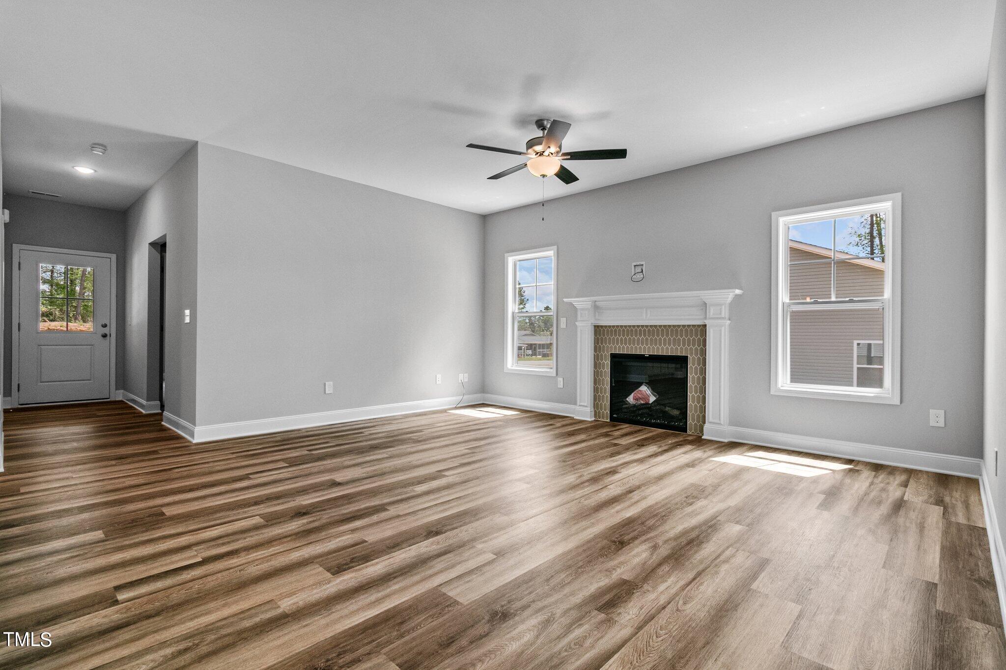 75 Regis Lane Coats, NC 27521 - Photo 10 of 37 a view of an empty room with wooden floor fireplace and a window