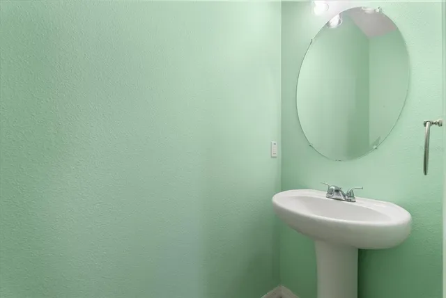 a bathroom with a sink and mirror