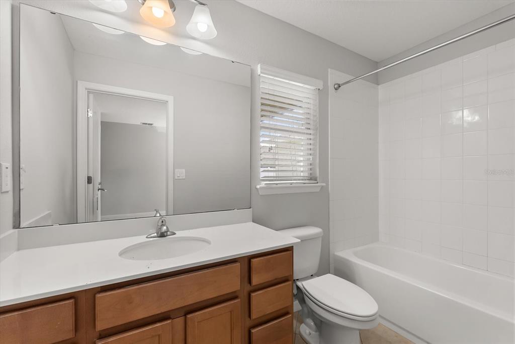 4345 Saltmarsh Sparrow Drive Windermere, FL 34786 - Photo 19 of 46 a bathroom with a sink toilet a mirror and shower