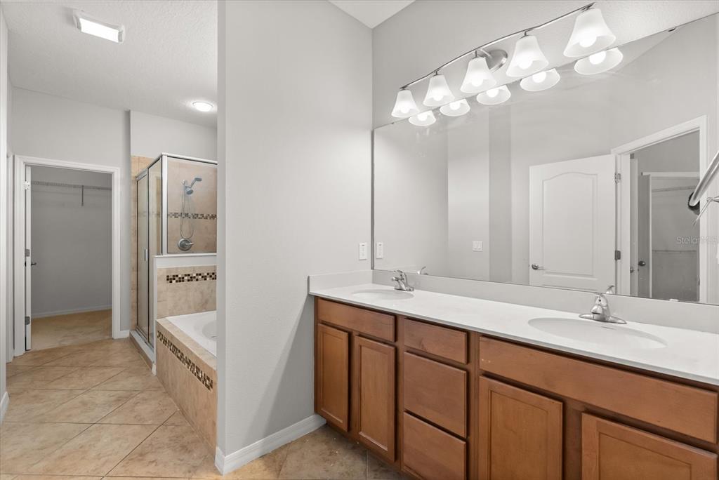 4345 Saltmarsh Sparrow Drive Windermere, FL 34786 - Photo 21 of 46 a bathroom with a double vanity sink and a mirror