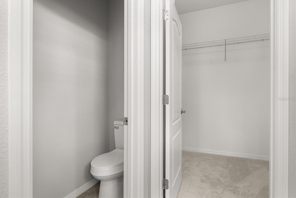 4345 Saltmarsh Sparrow Drive Windermere, FL 34786 - Photo 24 of 46 a bathroom with a granite countertop toilet and a sink