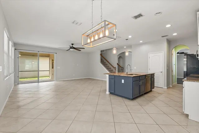a large room with a large window and cabinets