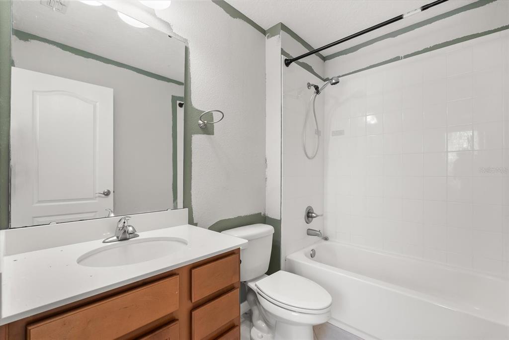 4345 Saltmarsh Sparrow Drive Windermere, FL 34786 - Photo 39 of 46 a bathroom with a granite countertop sink toilet and shower