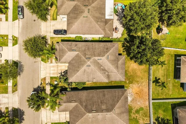 an aerial view of residential houses with outdoor space