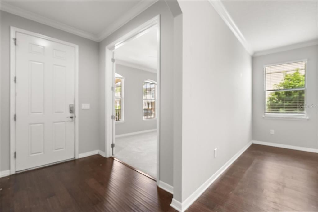 4345 Saltmarsh Sparrow Drive Windermere, FL 34786 - Photo 7 of 46 an empty room with wooden floor mirror and windows