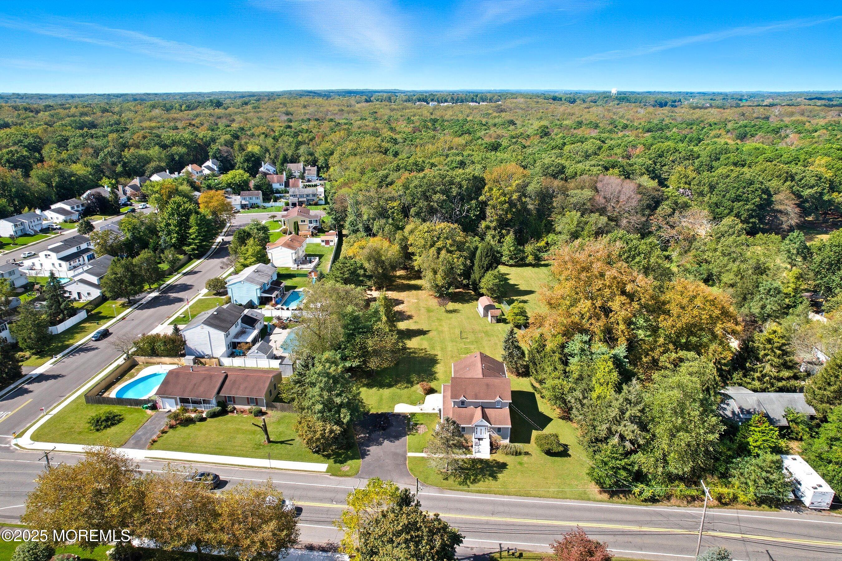 an aerial view of residential houses with outdoor space and street view