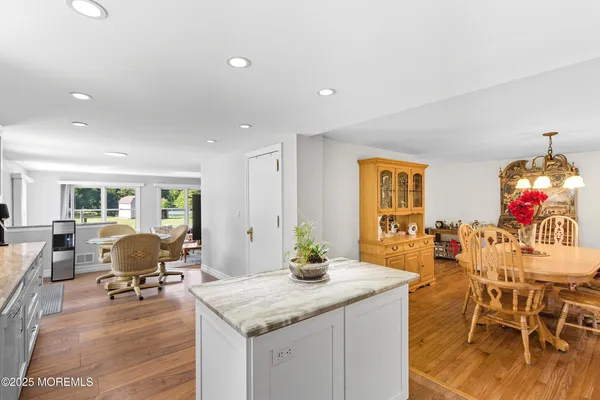 a view of a dining room with furniture wooden floor and chandelier