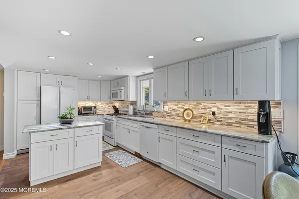 a kitchen with counter top space sink and cabinets