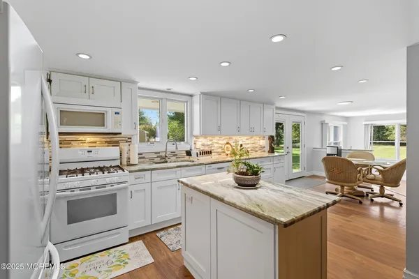 a kitchen with a stove a sink and a refrigerator