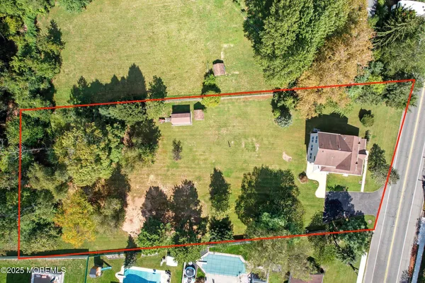 an aerial view of residential houses with outdoor space