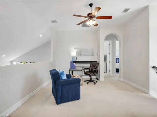 a living room with furniture a couch and a chandelier