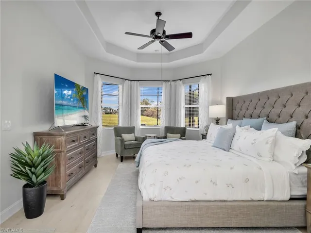 a bedroom with a bed and a large mirror