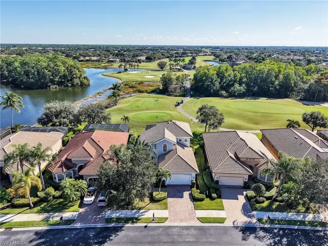 an aerial view of residential houses with outdoor space and river