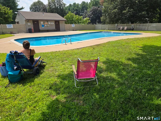 a view of a house with swimming pool and a yard