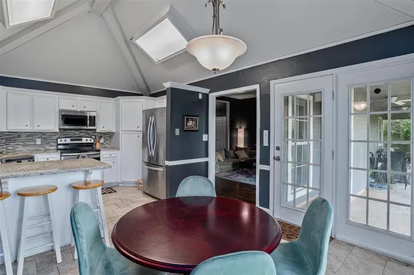 a kitchen with stainless steel appliances granite countertop a stove a sink and a microwave