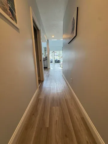 a view of hallway with wooden floor