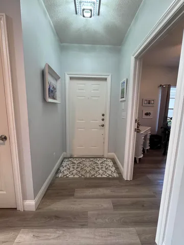 a view of a hallway view with wooden floor and bedroom view
