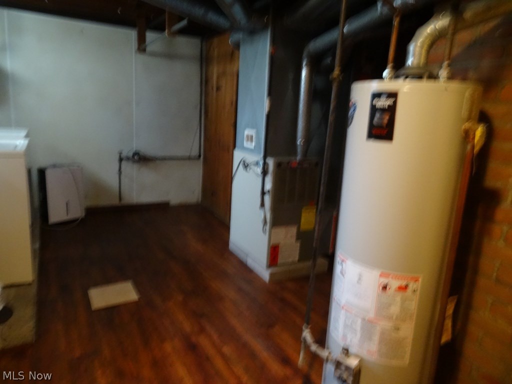 4767 Broadale Road Cleveland, OH 44109 - Photo 17 of 19 Furnace and hot water tank neatly tucked in utility side of the basement. Plus has an updated electric panel.