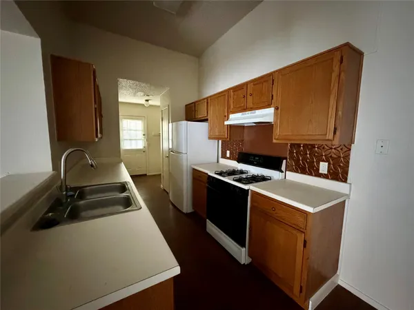 an empty room with a window and a ceiling fan