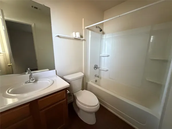 an empty room with a window and a ceiling fan