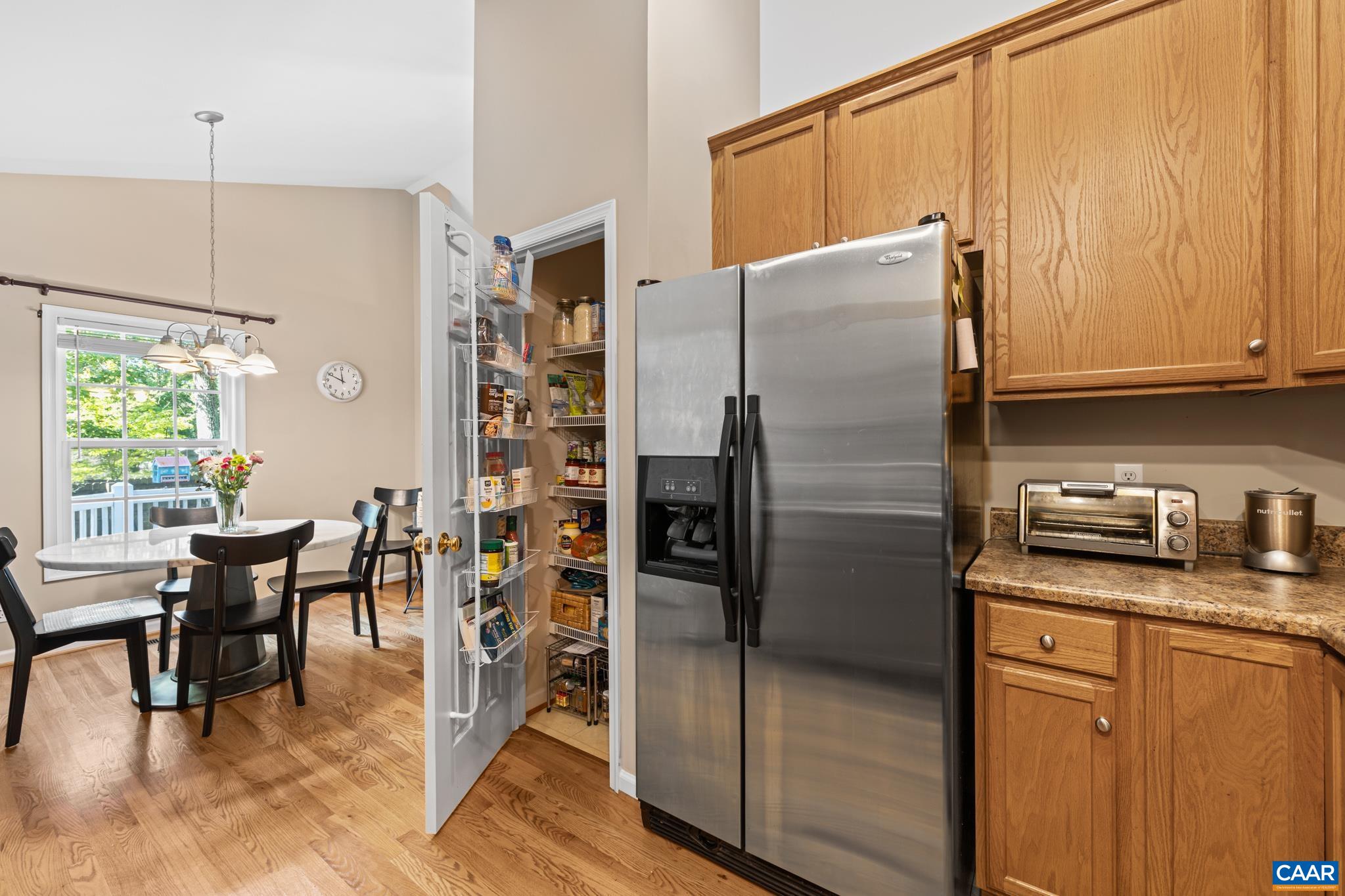 464 Hummingbird Road Scottsville, VA 24590 - Photo 15 of 31 a kitchen with stainless steel appliances granite countertop a refrigerator a stove a dining table and chairs with wooden floor