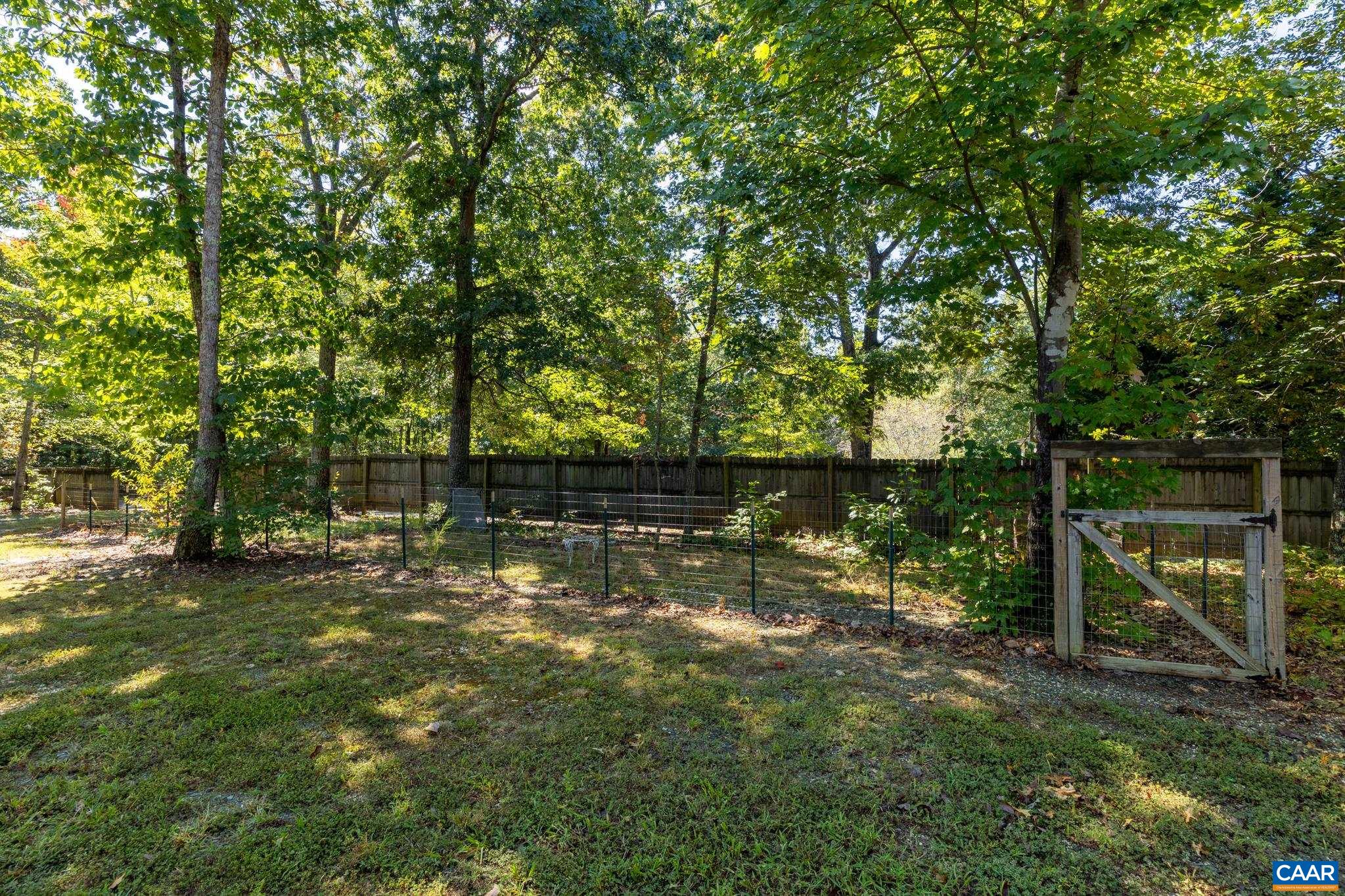464 Hummingbird Road Scottsville, VA 24590 - Photo 4 of 31 a backyard of a house with lots of green space