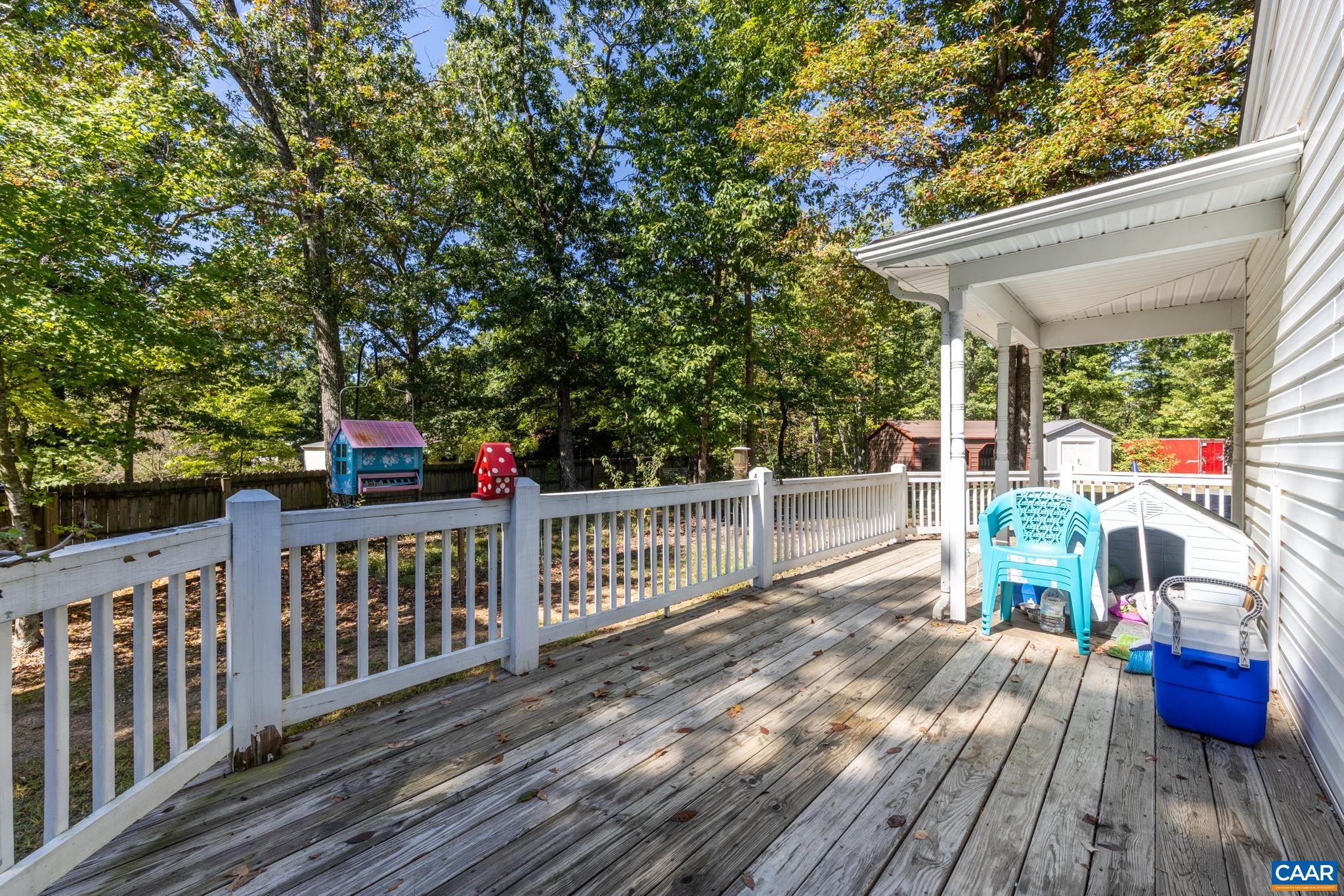 464 Hummingbird Road Scottsville, VA 24590 - Photo 8 of 31 a view of deck with table and chairs a barbeque with wooden floor and fence