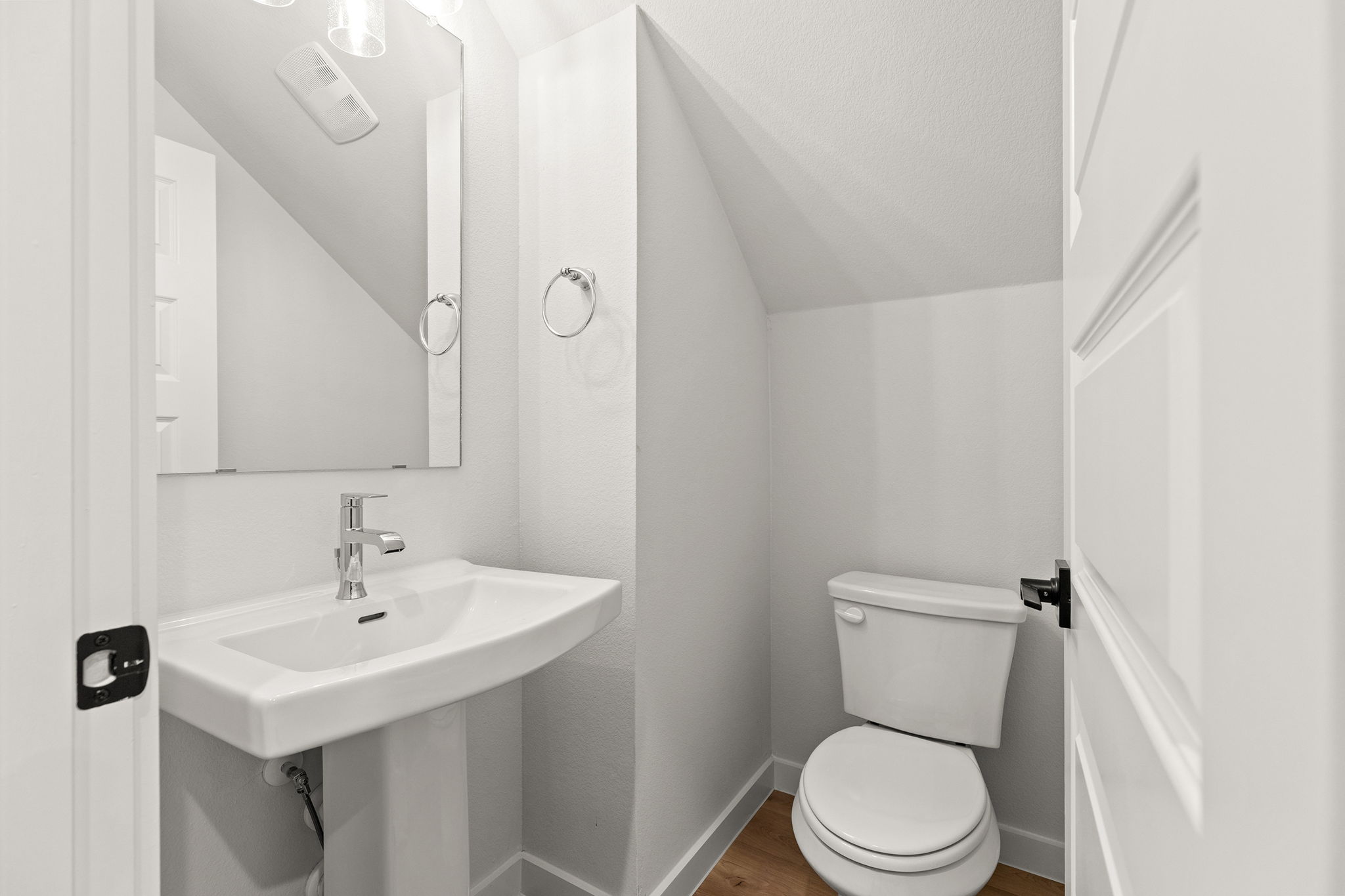 2600 Gattis School Road, Unit 1002 Round Rock, TX 78664 - Photo 30 of 40 A compact and functional bathroom features a sleek pedestal sink and convenient commode under a sloped ceiling.