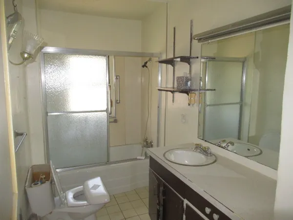 a bathroom with a sink toilet and shower