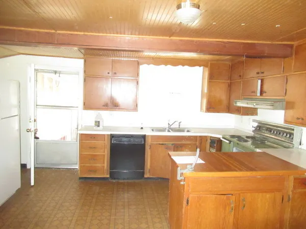 a room with a sink and a stove top oven